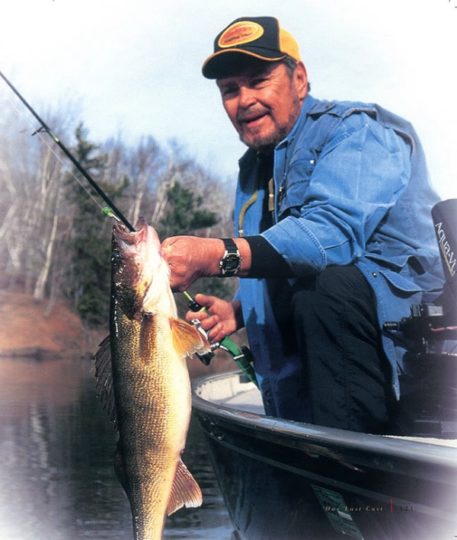 Ron Lindner holding up a walleye