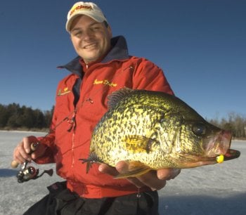 Jason Durham holding up a crappie he caught ice fishing with a Northland Fishing Tackle jig.