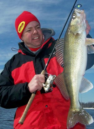 Travis Peterson with a walleye caught on a UV Fire-Ball Jig.