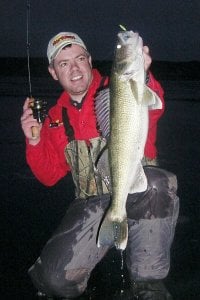 Travis Peterson with a night time walleye he caught.