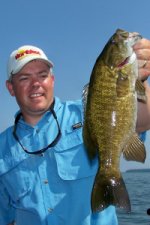 Travis Peterson holding up a smallmouth bass he caught fishing Mille Lacs.