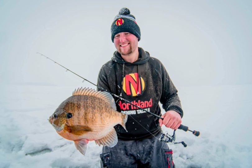 Ice fisherman with a bluegill he caught