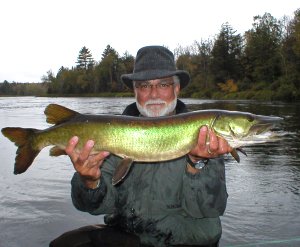 Bill Plantan holding up a muskie he caught.