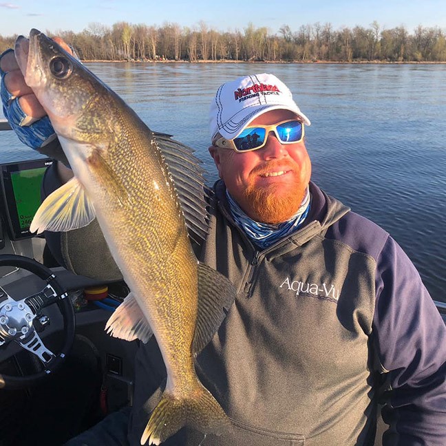 Fisherman holding walleye