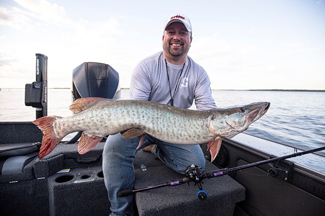 Fisherman holding up a musky he caught on the Rumble Beast crankbait