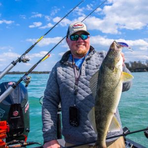 Fisherman holding up a walleye he caught trolling the Rumble Stick