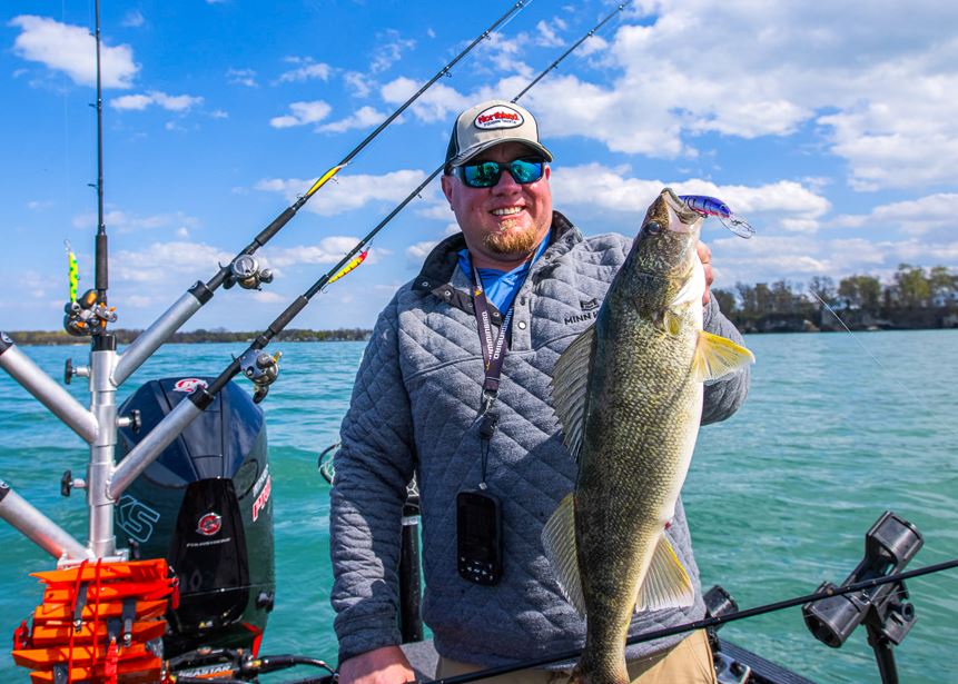 Fisherman holding up a walleye he caught trolling the Rumble Stick