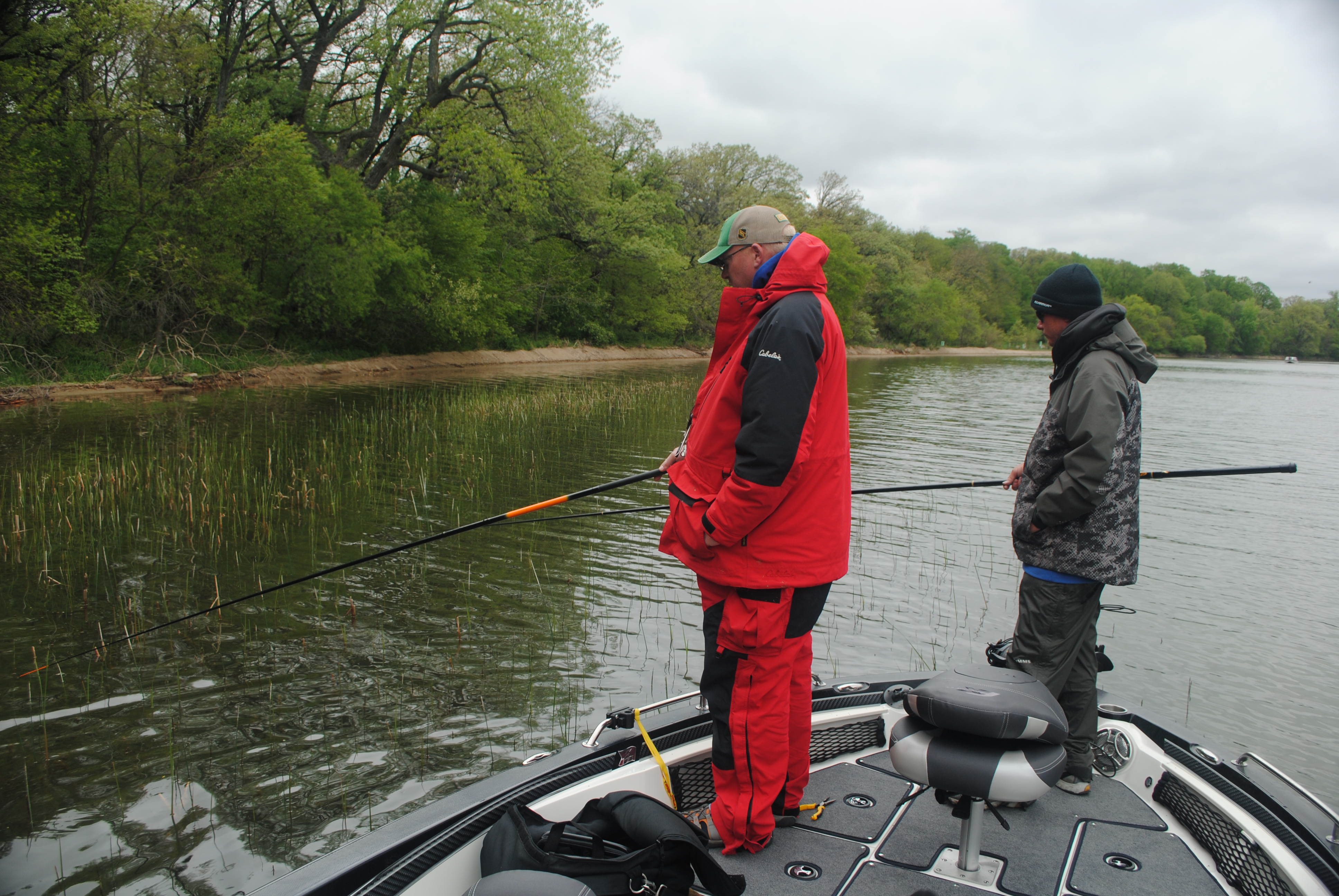 Two fisherman in shallow pencil reeds for crappie.