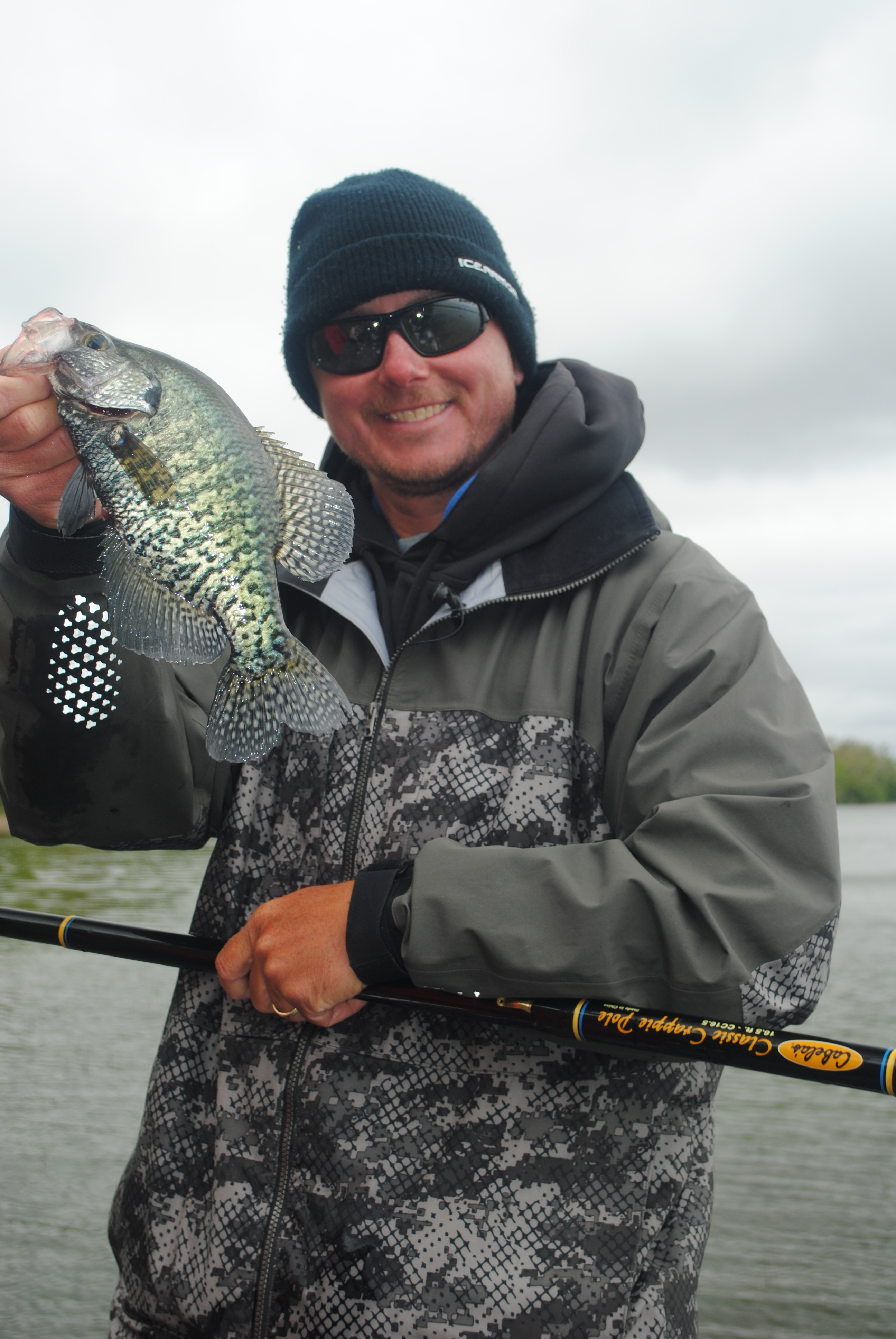 Fisherman showing off a crappie he caught fishing.