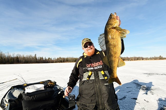 Bro holding up a big ice fishing walleye caught on a Buck-Shot Coffin Spoon