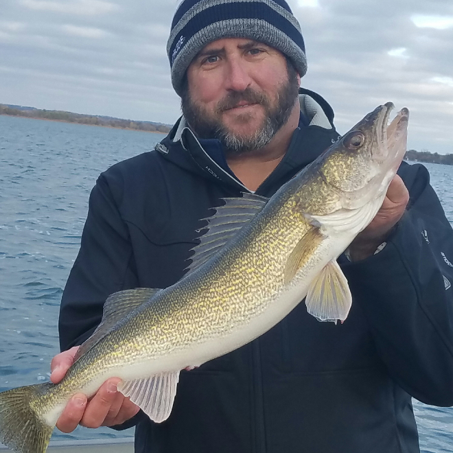 Angler with a walleye he caught fishing