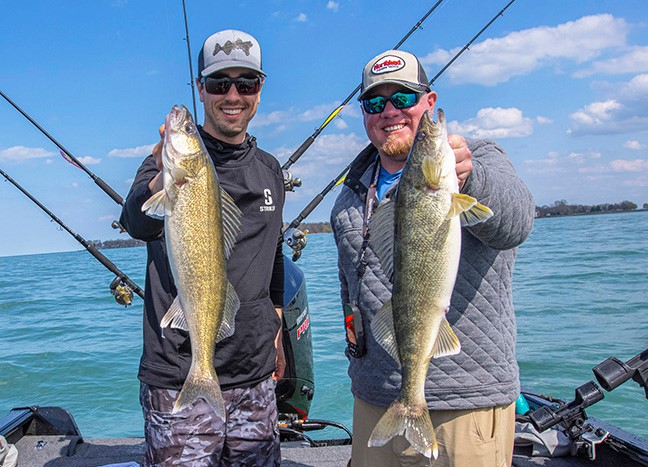 Two anglers holding up walleyes they caught trolling the Rumble B crankbait