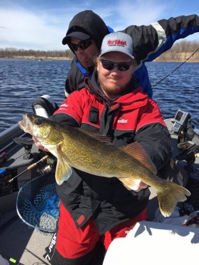 Fisherman with a walleye he caught while fishing.