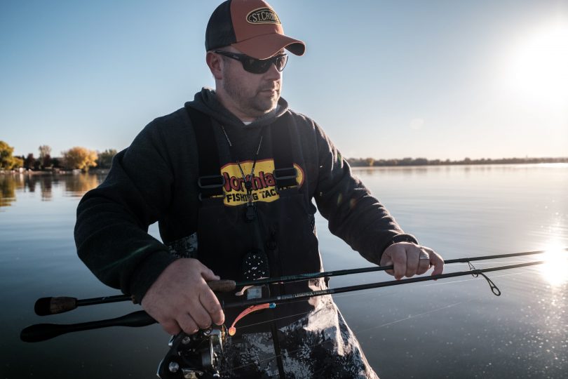 Walleye fisherman with two jigging fishing rods