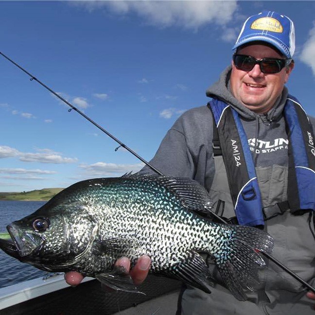 Jason Mitchell holding up a big crappie he caught fishing