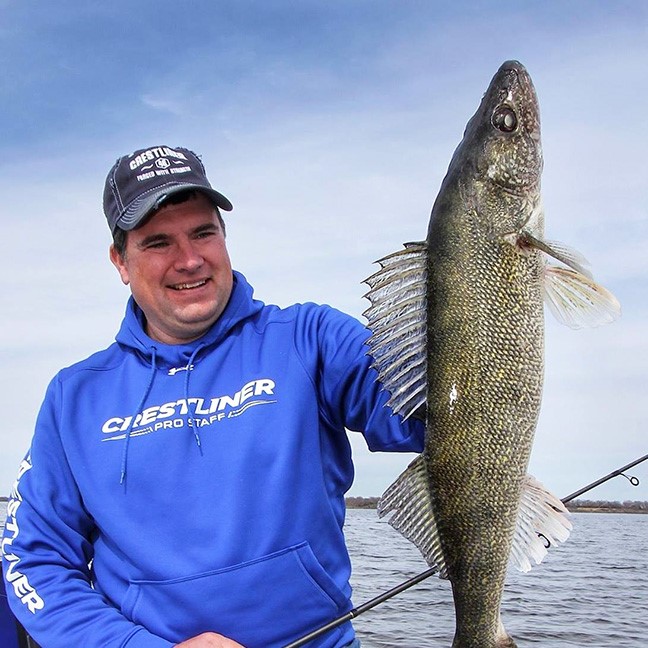 Jason Mitchell holding up a walleye he caught