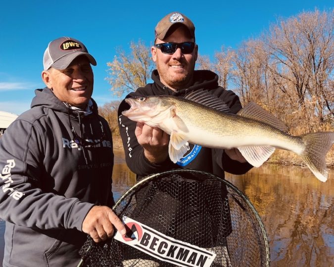 Two walleye fisherman showing off an opening day walleye they caught