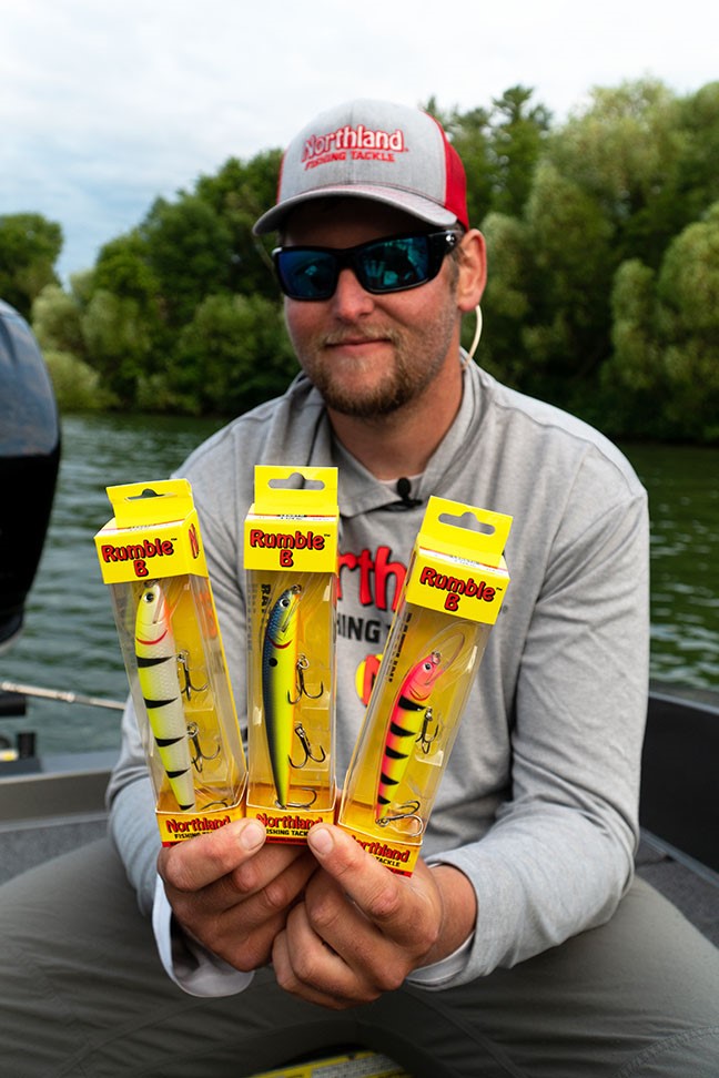 Walleye fisherman holding up three Rumble B crankbaits