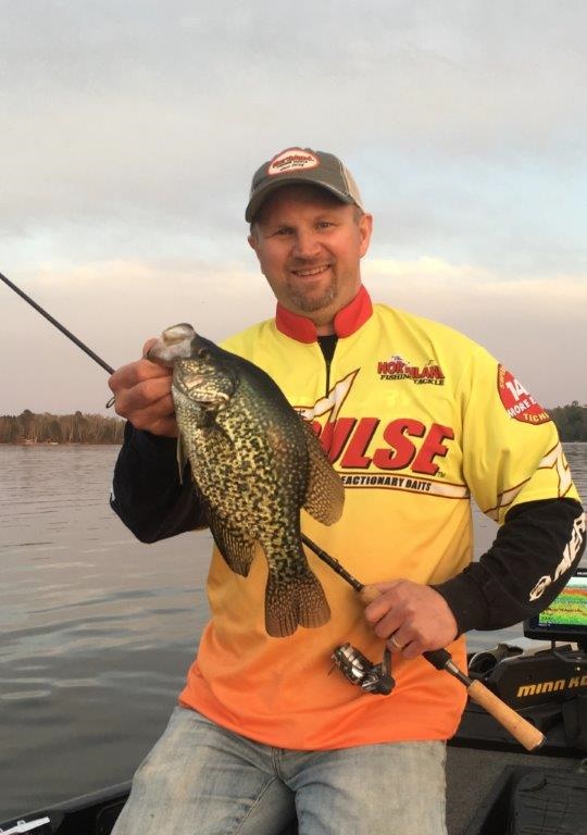 Fisherman holding up a spring crappie