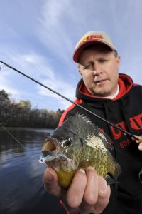 Fisherman with a bluegill he caught.