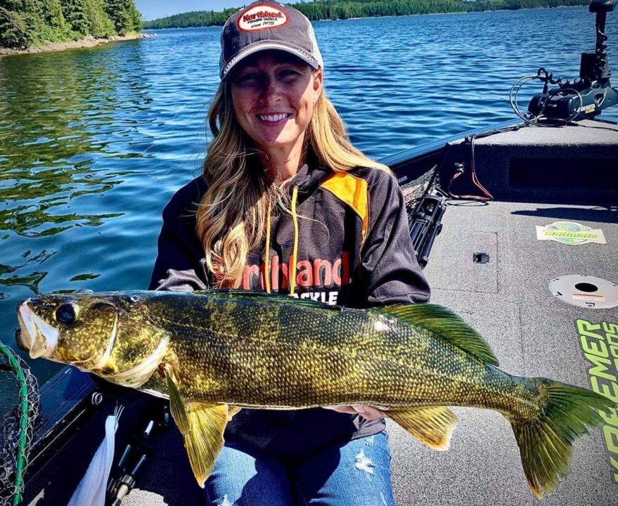 Female fisherman holding up a nice walleye