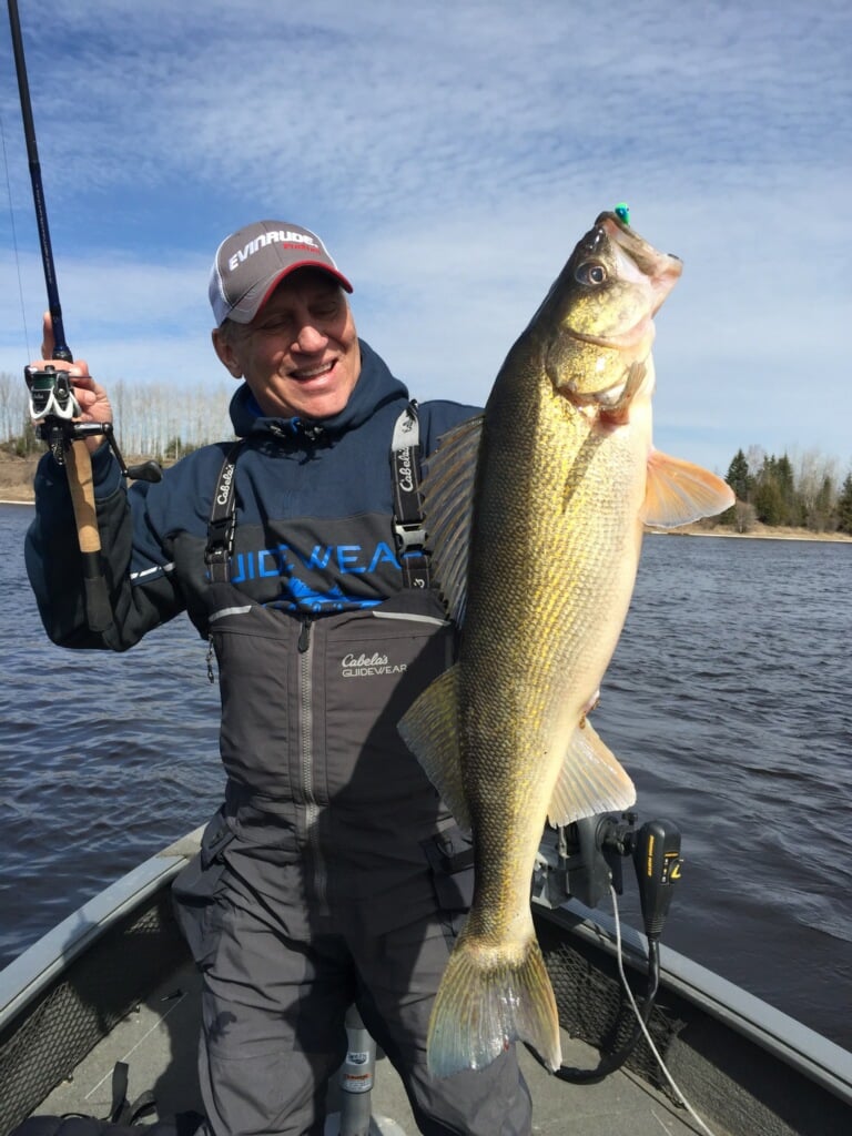 Fisherman holding a walleye caught on a Northland Fishing Tackle jig.