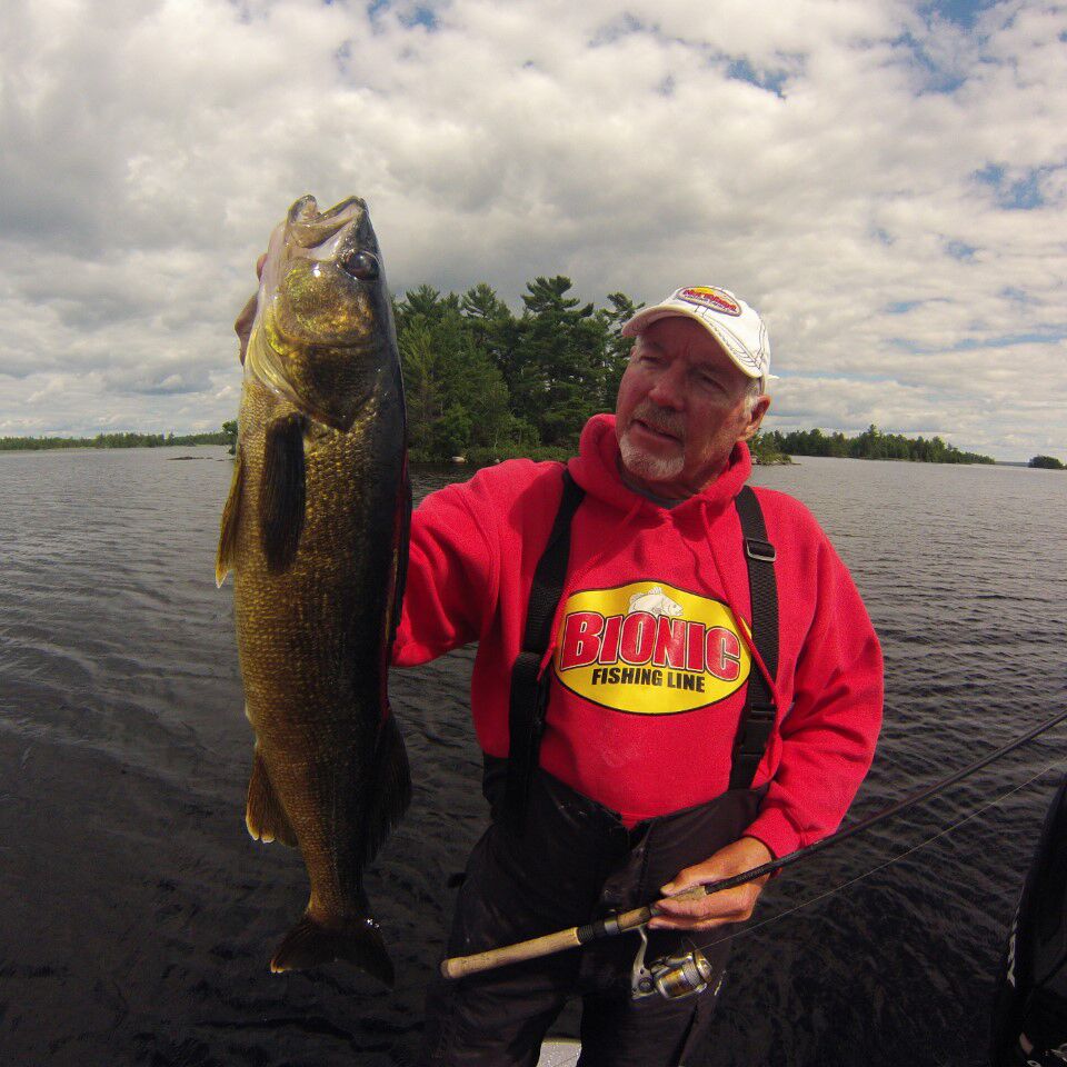 Fisherman holding up a big walleye caught on a Northland Fishing Tackle jig.